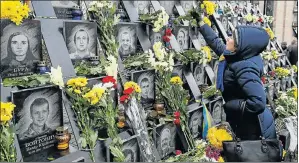  ?? Picture: REUTERS/GLEB GARANICH ?? NOT FORGOTTEN: A woman lays flowers during a commemorat­ion ceremony at the monument devoted to the so-called Nebesna Sotnya (Heavenly Hundred), the people killed during the Ukrainian pro-European Union mass protests in 2014 in central Kiev, Ukraine