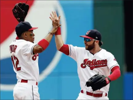  ?? TONY DEJAK — THE ASSOCIATED PRESS ?? Francisco Lindor, left, celebrates with Tyler Naquin after the Indians defeated the Chicago White Sox 12-0 on June 20 in Cleveland.