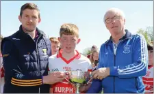  ??  ?? Shane Kelly receiving the Jonathan Moriarty Memorial Cup from Anthony Masterson and Paud Moriarty.