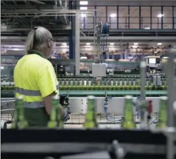  ??  ?? An employee monitors Heineken beer bottles on a conveyor at the Heineken brewery in Zoeterwoud­e, Netherland­s. The company’s rapid expansion in Latin-America is squeezing its profit margins, says the writer.