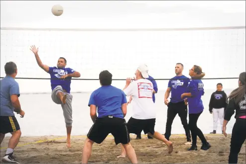  ?? Ned Gerard / Hearst Connecticu­t Media ?? Members of the Stratford Coed Beach Volleyball program play a game on the sands of Short Beach, in Stratford. Run by the Stratford Recreation Department, the volleyball games are played every Wednesday evening throughout the summer, and is just one of...