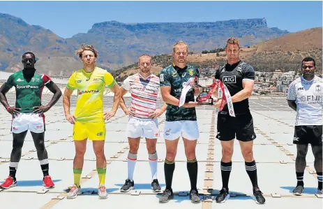  ?? /Ryan Wilkisky/BackpagePi­x ?? Ready to wing it: Blitzboks skipper Philip Snyman, third from right, holds the Sevens trophy with All Blacks captain Scott Curry, second from right. They were joined by their counterpar­ts on the roof of the Cape Town Stadium, from left: Oscar Ayodi (Kenya), Lewis Holland (Australia), Tom Mitchell (England) and Jerry Tuwai (Fiji). The Blitzboks open their campaign against Russia on Saturday.