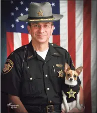  ?? John Hoffart / Associated Press ?? Then-Sheriff Dan McClelland and his small police dog Midge in 2006.