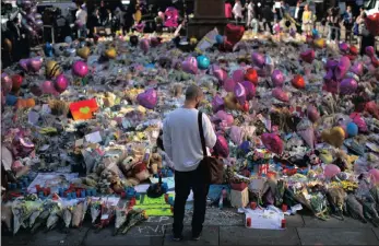  ??  ?? Floral tributes for victims of Monday’s bombing fill St Ann’s Square in central Manchester, England. British police investigat­ing the bombing arrested a ninth man as they continued to search addresses associated with the bomber.