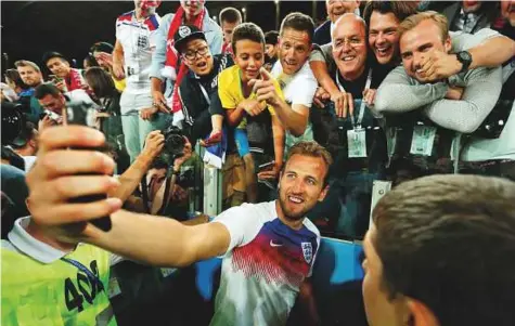  ?? Reuters ?? England’s Harry Kane takes a selfie with fans after the match against Colombia. Kane showed incredible composure in winning the penalty under a challenge from Carlos Sanchez, displaying the street-wise edge that England supporters have long cried for.
