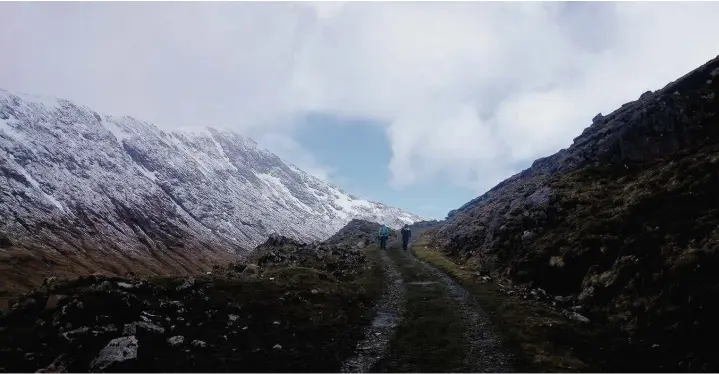  ??  ?? The dramatic landscape on the approach to the Cruachan range at the side of Loch Awe (above), and climbing up a snowfield to attain the ridge before the final clamber over boulders to the summit of mighty Ben Cruachan (below)