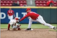  ?? JOHN MINCHILLO — THE ASSOCIATED PRESS ?? Philadelph­ia Phillies’ Andrew Knapp, left, is picked off by Cincinnati Reds shortstop Zack Cozart in the sixth inning of a baseball game Thursday in Cincinnati.