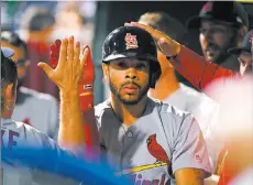  ?? Eric Hartline ?? USA Today Durango product Tommy Pham is greeted in the Cardinals’ dugout Wednesday after the second of his two home runs in St. Louis’ 7-6, 10-inning win over the Phillies at Citizens Bank Park. He went deep in the fifth and ninth.