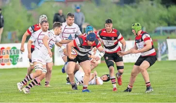  ?? ?? Charge George Breese takes on the Bulls defence. All photos by Bryan Robertson Photograph­y