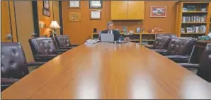  ?? (AP/Eric Gay) ?? Superinten­dent Brian Woods of Northside Independen­t School District in Texas works alone Monday at a conference table as he prepares for a meeting in San Antonio.