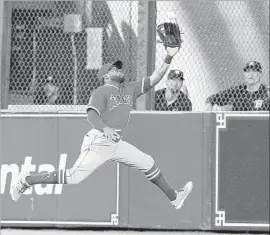  ?? Bob Levey Getty Images ?? ANGELS center fielder Eric Young Jr. snags a deep drive by the Astros’ Yuli Gurriel. The teams hit only one homer against starters who’d combined to give up 36.