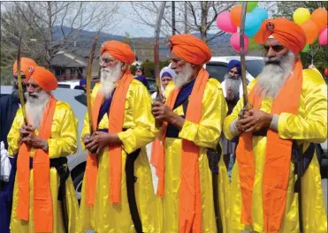  ?? ANDREA PEACOCK /The Okanagan Sunday ?? Brightly coloured Sikhs from the Kelowna Sikh Temple were part of the 7th annual Kelowna Vaisakhi Parade. Minister of National Defence Harjit Sajjan was in town to attend the event, which attracts thousands of people every year.