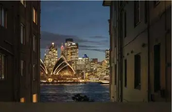  ?? BLOOMBERG PIC ?? Commercial space in Sydney is being squeezed as buildings are torn down to make way for a A$12.5 billion metro line, while developers are cashing in on the housing boom by converting harboursid­e towers into luxury apartments.