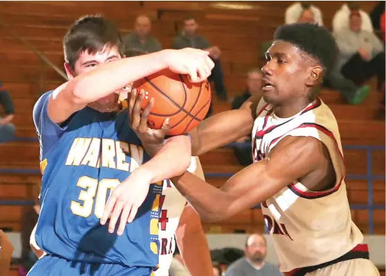  ?? | ALLEN CUNNINGHAM/ FOR THE SUN- TIMES ?? West Aurora’s Jared Crutcher ( right, battling for a rebound withWarren’s Jacob Rich) has come on strong in the second half of the season.