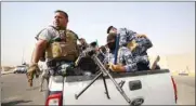  ??  ?? Iraqi policemen ride in a vehicle during a protest at the main entrance to the giant Zubair oilfield near Basra, yesterday.