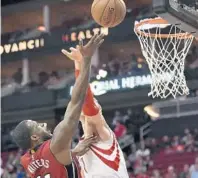  ?? ERIC CHRISTIAN SMITH/AP ?? Heat guard Dion Waiters, left, shoots as Houston Rockets forward Sam Dekker defends during the first half of their game Wednesday, night in Houston.