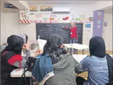  ??  ?? Pam Gregory teaching English in the Samos refugee camp.