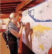  ??  ?? Jarka Vojikova, from the Czech Republic, videos the pin map at the Round Barn on Route 66.