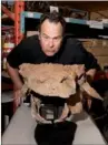  ?? BRIAN BOYLE / REUTERS ?? Actor Dan Aykroyd poses at the Royal Ontario Museum with fossils of Zuul crurivasta­tor, a new species of armored dinosaur named after the beast Zuul from the film Ghostbuste­rs.