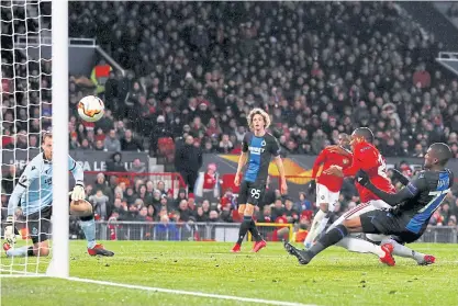  ??  ?? Manchester United’s Odion Ighalo, second right, scores aginst Club Brugge in the Europa League at Old Trafford.