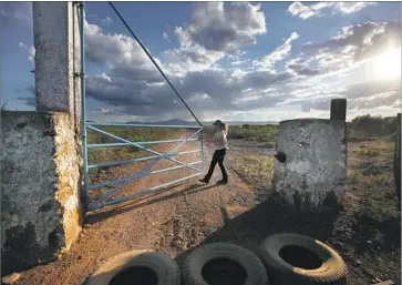  ?? Photograph­s by Francine Orr Los Angeles Times ?? CLAUDIA CORDERO closes the gate behind her truck as she and her husband arrive on her family’s ranch in Moctezuma. “He takes off his uniform and he completely transforms,” she says. “It’s work, but it’s not stress.”