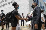  ?? JAKE CRANDALL / MONTGOMERY ADVERTISER ?? Grace Jackson greets Mayor Steven Reed at a Black Lives Matter protest in Montgomery: “We are the legacy of the civil rights movement.”