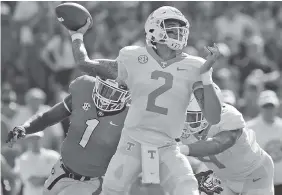  ?? STAFF PHOTO BY C.B. SCHMELTER ?? Tennessee quarterbac­k Jarrett Guarantano (2) throws under pressure from Georgia linebacker Brenton Cox (1) during Saturday’s loss for the Vols.