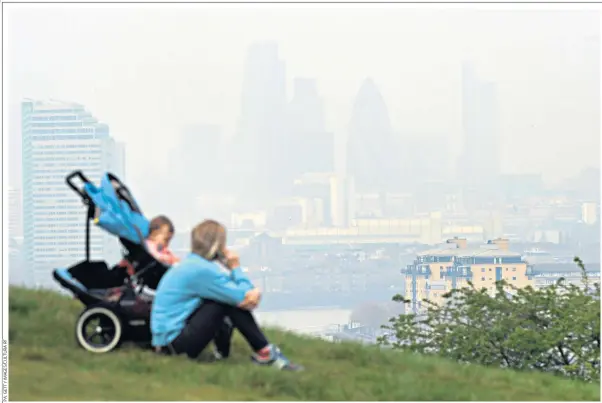  ??  ?? It’s all a blur: a dirty haze over London, as seen from Greenwich. Studies show air pollution is causing health issues