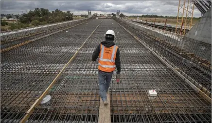  ?? ROBERT GAUTHIER — LOS ANGELES TIMES ?? A constructi­on wokers walks on the Fresno Trench section of the California High Speed Rail Project in April 2019. Constructi­on is currently taking place on about 119miles of the planned route from north of Madera to northwest of Bakersfiel­d. A request for federal funding has been denied.