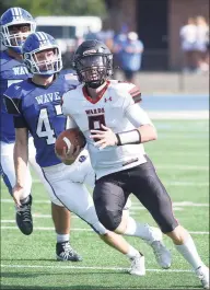  ?? Dave Stewart / Hearst Connecticu­t Media ?? Warde quarterbac­k Charles Gulbin runs for some yards as Darien’s Mason Hedley pursues on Saturday.