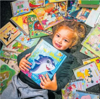  ?? ?? Piper, 2, is already a little bookworm, pictured here with some of her mother’s 638 Little Golden Books.