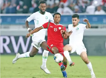  ?? (AFP) ?? Oman's Al Mandhar al Alawi (centre) vies for the ball with Saudi's defender Sultan Abdulla (right) in the Qatari capital Doha on Monday