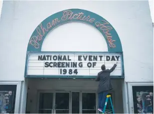  ?? (Adrees Latif/Reuters) ?? AN EMPLOYEE at New York’s Picture House Regional Film Center places letters on a sign board ahead of its screening of ‘1984.’