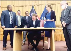  ?? Julia Bergman/Hearst Connecticu­t Media ?? Gov. Ned Lamont signs a bill Tuesday making recreation­al marijuana legal for adults in Connecticu­t, starting July 1. From left are proponents Sen. Gary Winfield, D-New Haven; Rep. Steve Stafstrom, D-Bridgeport; House Majority Leader Jason Rojas, D-East Hartford; Lamont; Lt. Gov. Susan Bysiewicz, and Senate President Pro-Tem Martin Looney, D-New Haven.