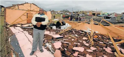  ?? Picture LULAMILE FENI ?? BIG LOSS: Mthatha pastor Malibongwe Mlungwana at his stormwreck­ed church hall. He said storm damage to the hall, houses, a car, sheep, furniture and groceries, amounted to R2-million