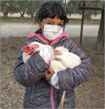  ?? GRIMM FAMILY EDUCATION FOUNDATION ?? A student befriends a hen at the Winter Camp at the Edible Schoolyard Kern County. Enrollment is open now for the Spring Camp, which starts later this month.