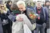  ?? ?? Yulia Navalnaya, widow of the late Kremlin opposition leader Alexei Navalny, embraces a woman at a rally next to the Russian embassy in Berlin, where voters lined up to cast their ballots in Russia’s presidenti­al election on Sunday.