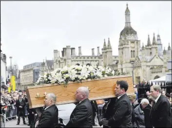  ??  ?? The coffin of renowned physicist and author Stephen Hawking arrives Saturday at St. Mary the Great church as mourners gather to pay their respects in Cambridge, England.