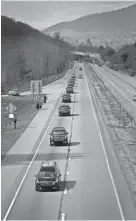  ?? ANGELA WILHELM/CITIZEN TIMES ?? The motorcade carrying the body of the Rev. Billy Graham heads out of the mountains toward Charlotte, N.C., on Saturday.