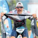  ?? Photo / Getty Images ?? Jan Frodeno celebrates his third straight Ironman world title.