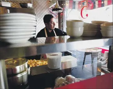  ?? Gary Coronado Los Angeles Times ?? SAUL CORTEZ dices potatoes at downtown L.A.’s Nickel Diner, whose owners say California’s minimumwag­e increase will hurt them. Minimum wage for most workers will rise to $11 an hour on New Year’s Day.