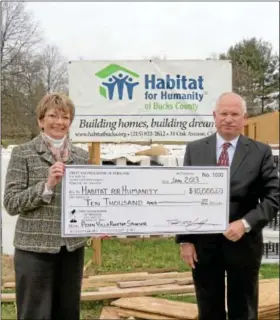  ??  ?? DONATED ... First Savings CEO Fred Shea, right, presents a check for $10,000 to Florence A. Kawoczka, executive director of Habitat for Humanity of Bucks County. First Savings has stepped forward as a $10,000 Rooftop Sponsor for the Penn Villa project...