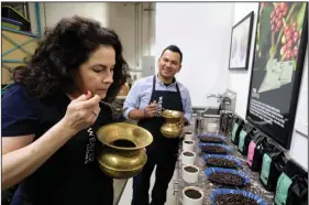  ?? (AP/Eric Risberg) ?? In this photo taken last week, Renee Brown, vice-president of Wild Card Roasters, samples different coffees as assistant roaster Carlos Garcia looks on at her roastery and cafe in San Rafael, Calif.