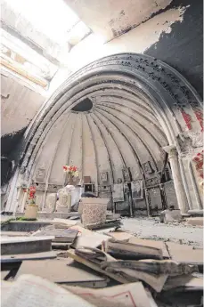  ?? FOTO: LUDGER MÖLLERS ?? In der Kirche von Karakosch in der Ninive-Ebene hat die Terrormili­z IS alle christlich­en Symbole zerstört. Die wenigen Christen, die langsam zurückkehr­en, haben Blumen in die Trümmer gestellt.