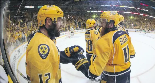  ?? BRUCE BENNETT/GETTY IMAGES ?? Nashville Predators centre Mike Fisher, left, seen celebratin­g a goal against the Pittsburgh Penguins in Game 3 on Saturday in Nashville, Tenn., says he doesn’t really look at himself “as a celebrity. … As far as being a celebrity, my wife gets more...