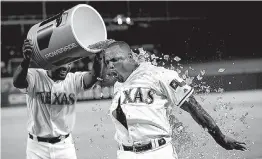  ?? Associated Press ?? Texas Rangers’ Adrian Beltre, right, gets doused by teammate Elvis Andrus after Beltre hit a game-winning, two-run home run Monday during the ninth inning against the Oakland Athletics in Arlington.