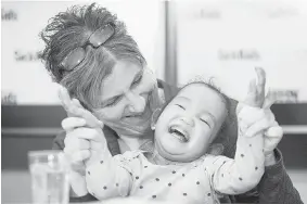  ?? TYLER ANDERSON/National Post ?? Johanne Wagner and her daughter Phuoc, age three, share a laugh during a news conference in Toronto, Tuesday. Her twin sister Binh, also recently received a life-saving liver transplant.