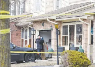  ?? CP PHOTO ?? A forensic investigat­or takes photograph­s at a home in Ajax, Ont., on Thursday.