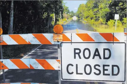  ?? Meg Kinnard ?? The Associated Press A sign stands near the Carter’s Crossroads community Wednesday in Georgetown County, S.C. This is one of many low-lying areas in this and other nearby farming communitie­s where roads are blocked off days after the rains of Florence have stopped.