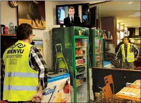  ?? AP/BOB EDME ?? Yohann Piedagnel watches French President Emmanuel Macron from Hendaye, France, during Monday’s televised address to the nation.